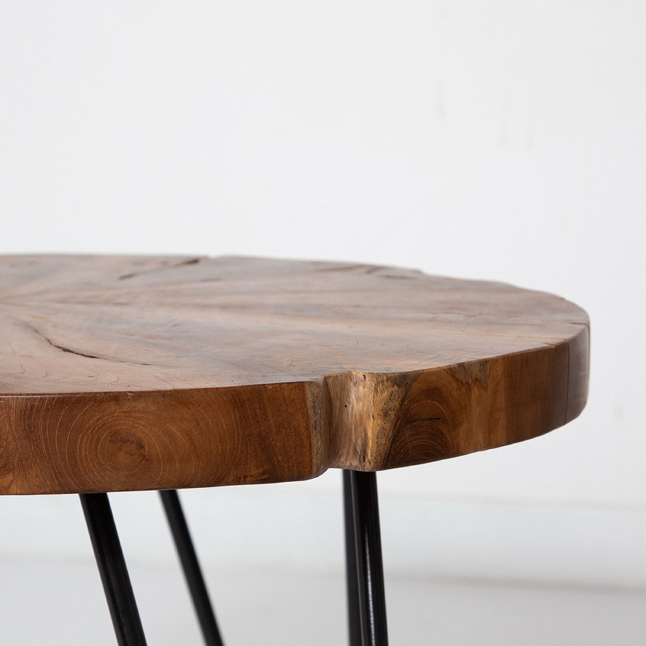 Wooden table with black metal legs on a white background