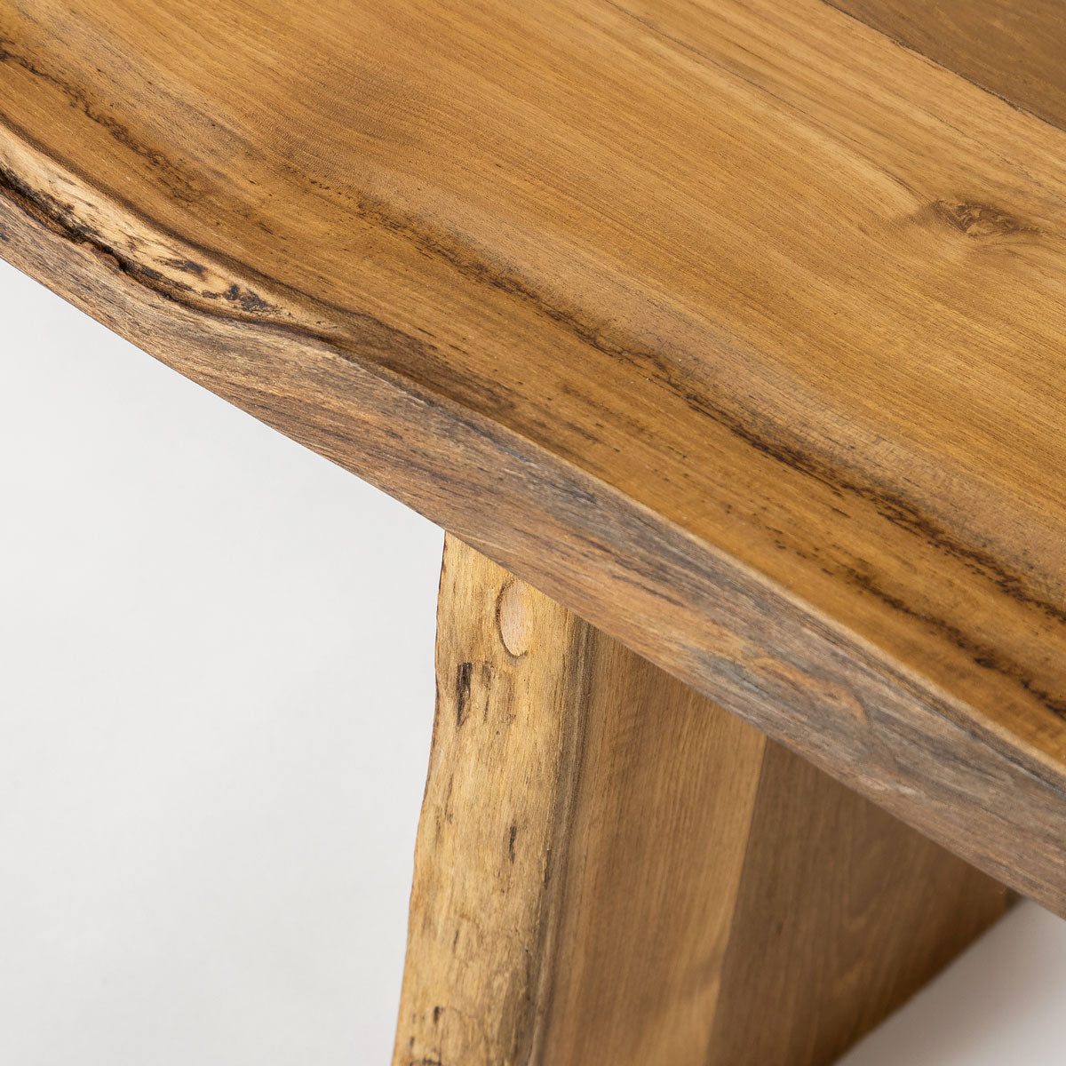 Close-up of a wooden stool with a natural finish on a white background