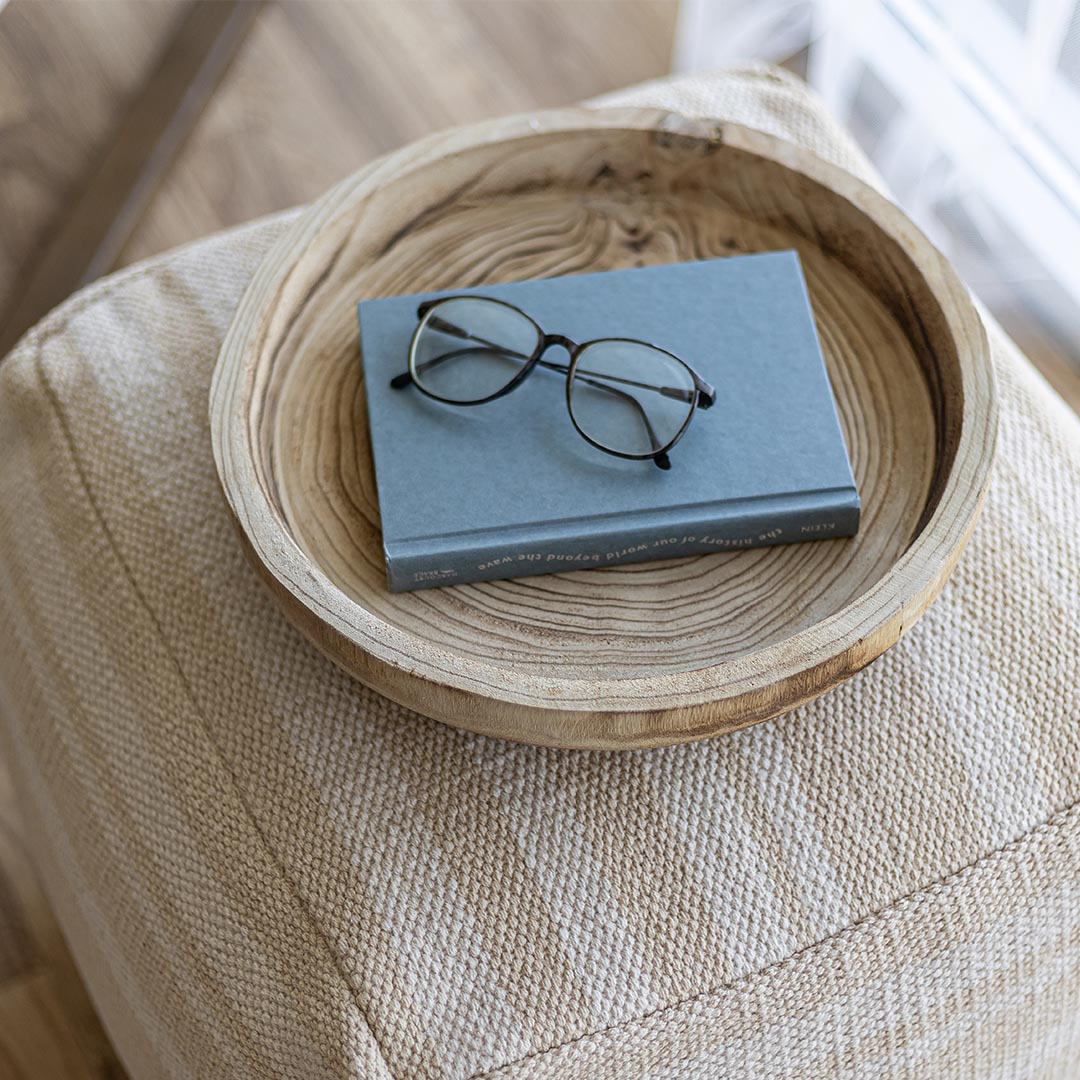 Wooden bowl with concentric circular pattern on a white background