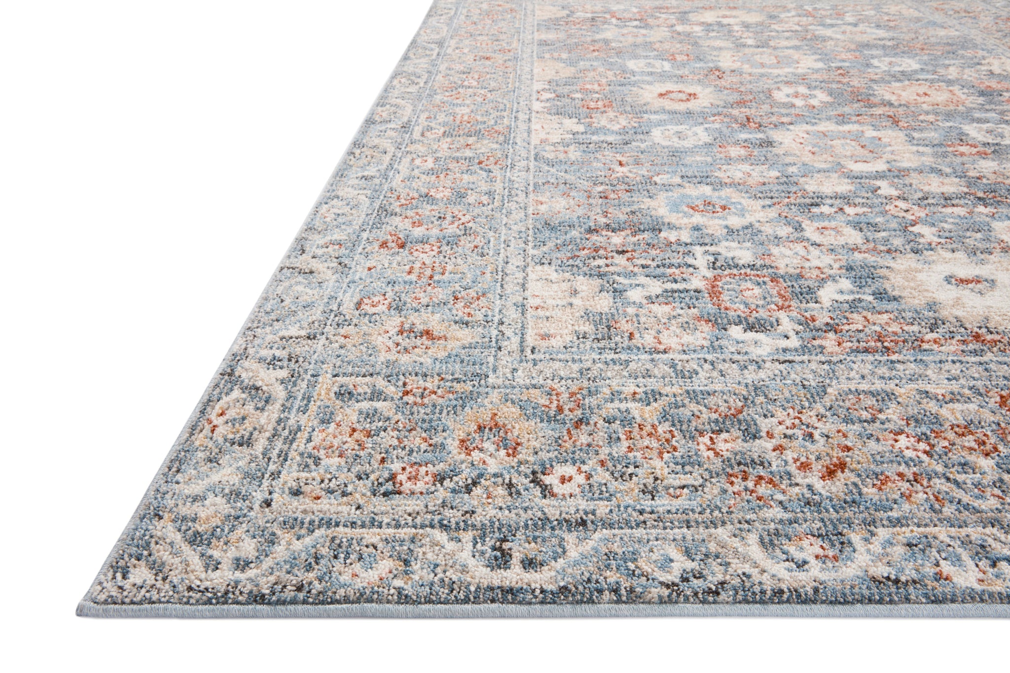 side view of Odette Sky / Rust luxury Rug