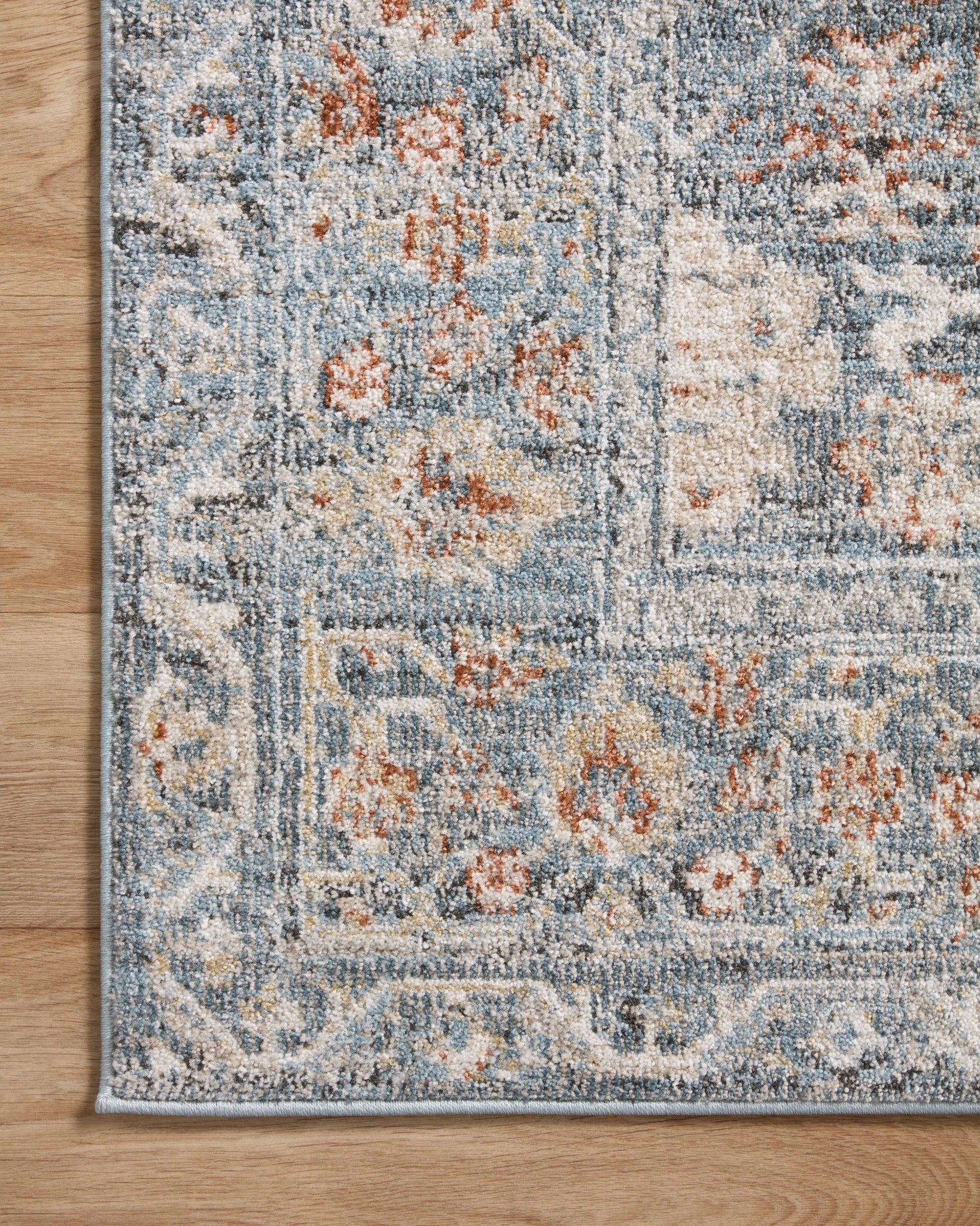 lifestyle view of Odette Sky / Rust luxury Rug