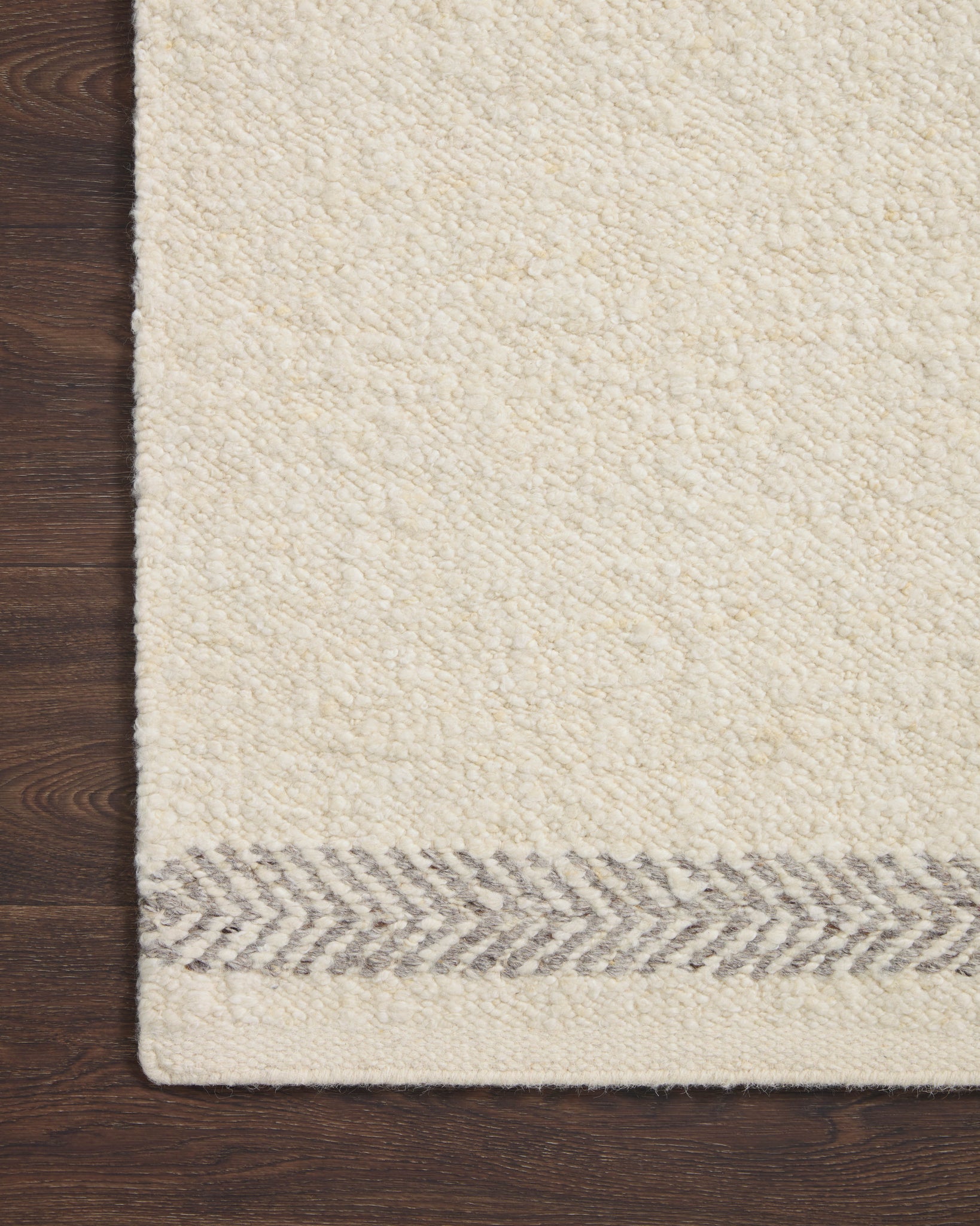 side view of Reyla Ivory / Silver luxury Rug