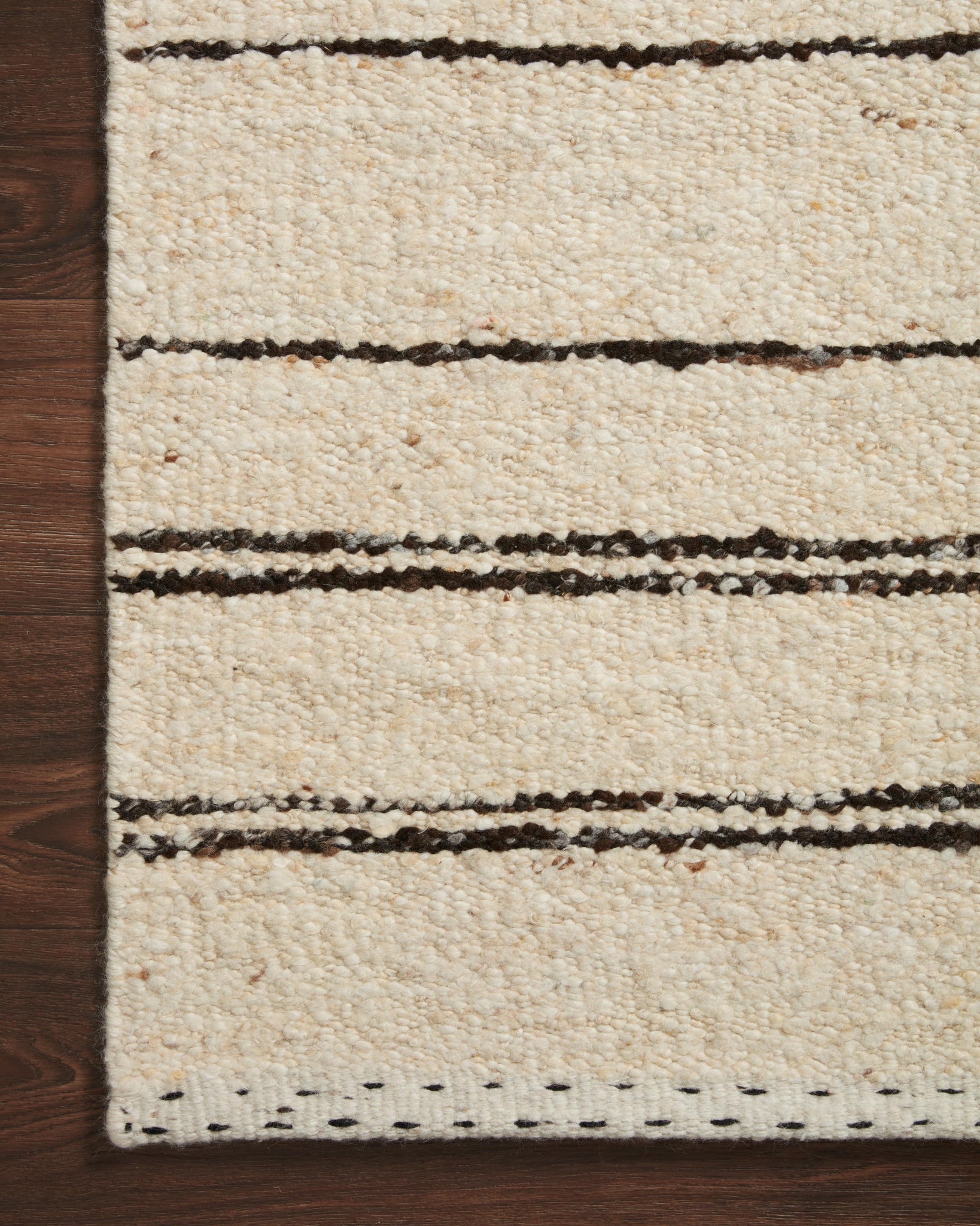 side view of Roman Natural / Charcoal luxury Rug