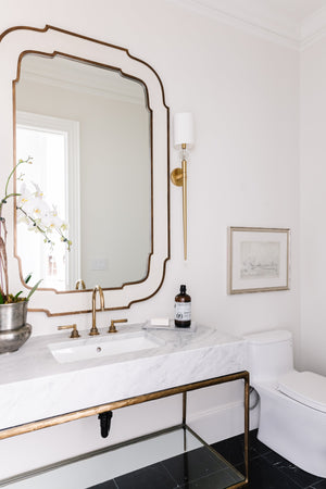 Rockland Wall Sconce 5.25" in aged brass styled in a curated living room for warm, layered light at Laurie Yapp Home.