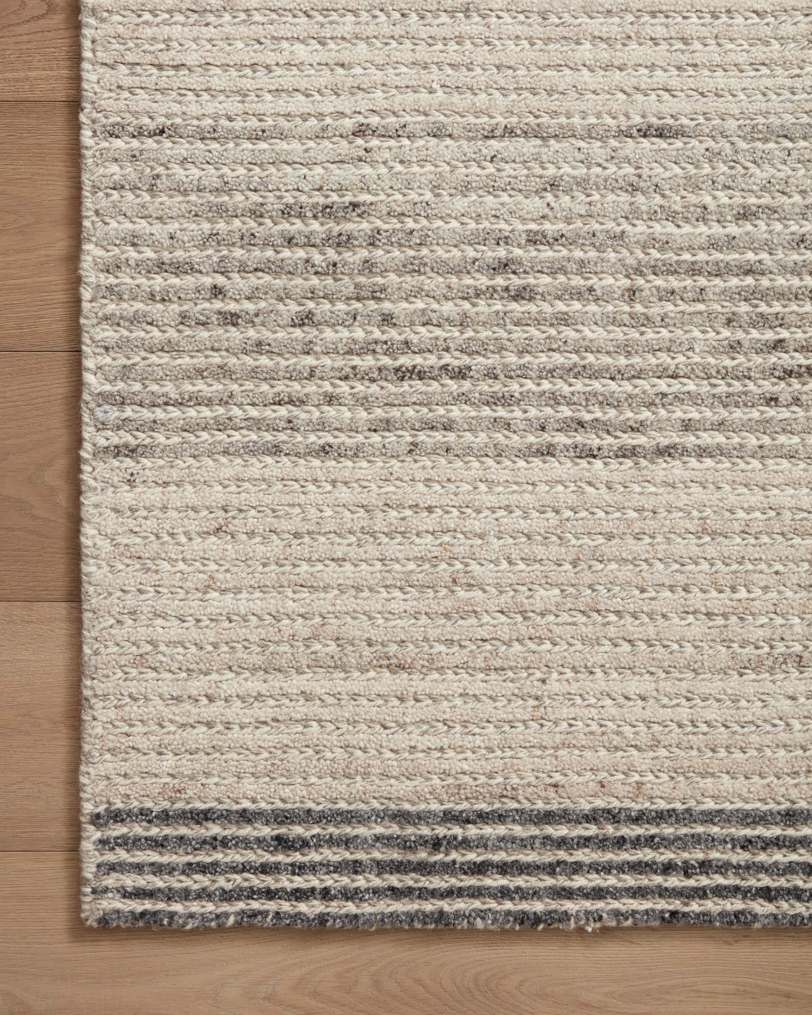 side view of Stiles Dove / Ink luxury Rug
