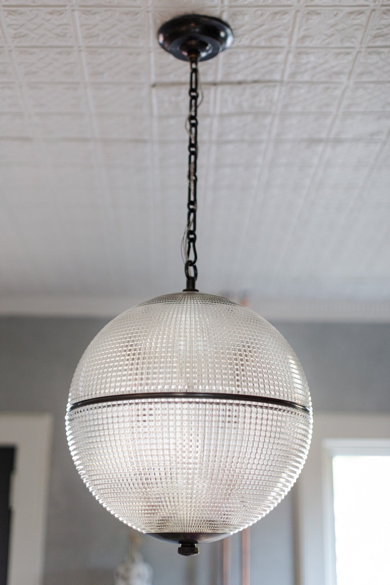 Sphere No. 3 Pendant 18.25" in dark bronze styled in a bright kitchen for warm, layered light at Laurie Yapp Home.