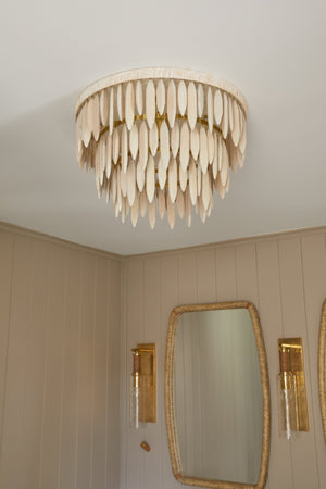 Eastchester Wall Sconce in aged brass styled in a warmly lit hallway for warm, layered light at Laurie Yapp Home.