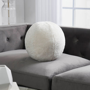 Freddie Indoor Pillow placed on a gray couch, showcasing its round shape and fluffy cream fabric.