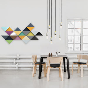 Tremulous Triangle Wall Decor displayed above a dining table with modern chairs and pendant lights.