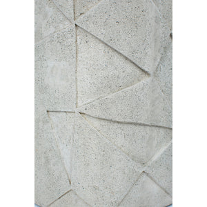Nodin Side Table close-up of textured light gray concrete with angular design