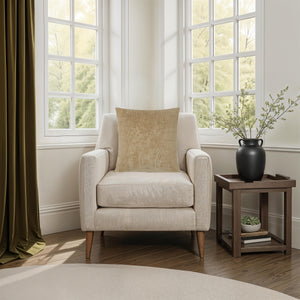 Oceana pillow by Renwil on a cozy armchair beside a window