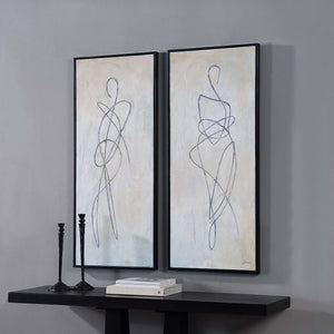 Self canvas art by Renwil displayed on a wall with black candlesticks and books on a table