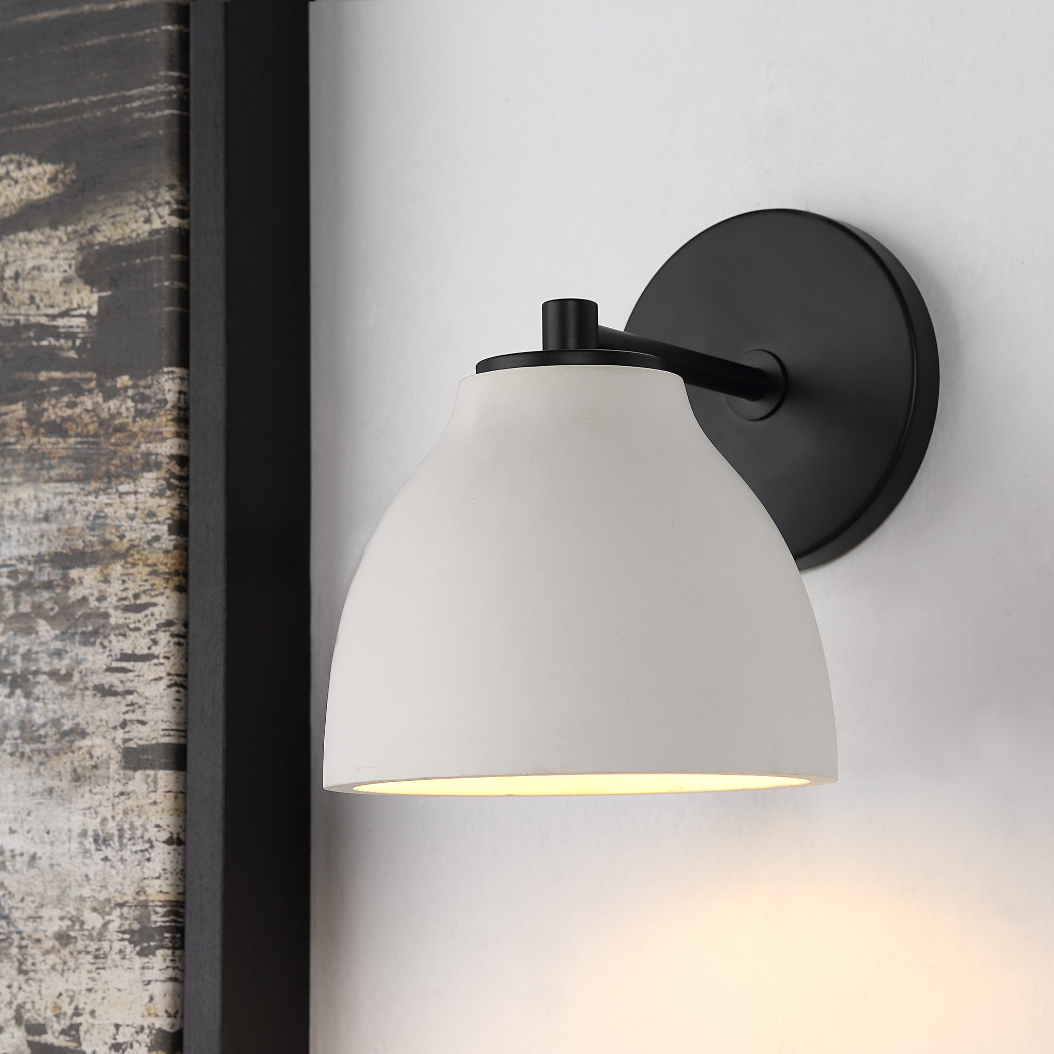 Lena Wall Sconce mounted on a wall, illuminating with a warm light.