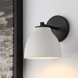 Lena Wall Sconce mounted on a wall, illuminating with a warm light.
