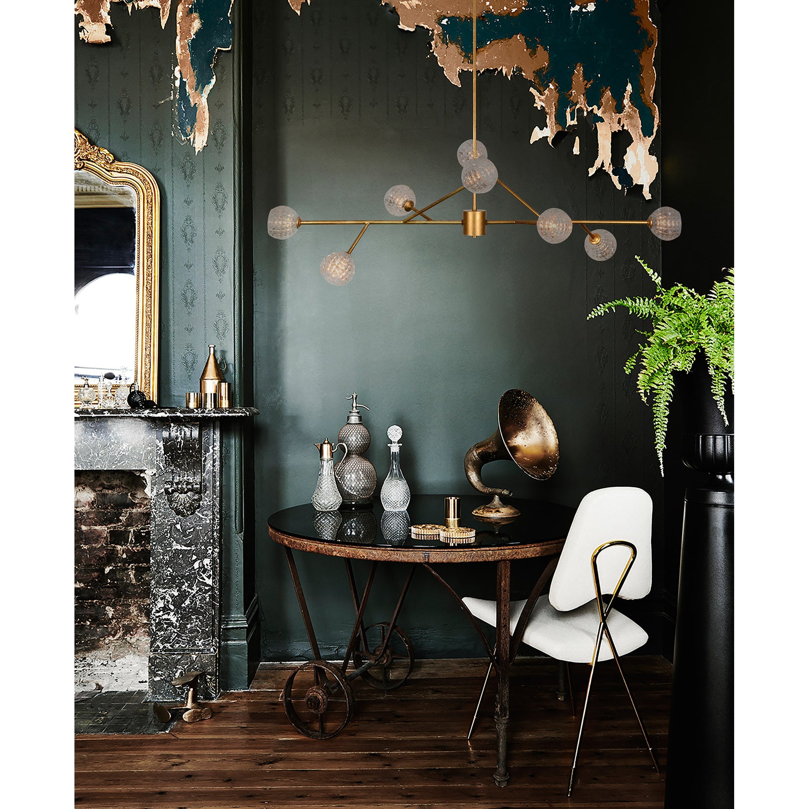 Damas Ceiling Fixture in a stylish interior, featuring gold finish and glass globes above a round table with decor.