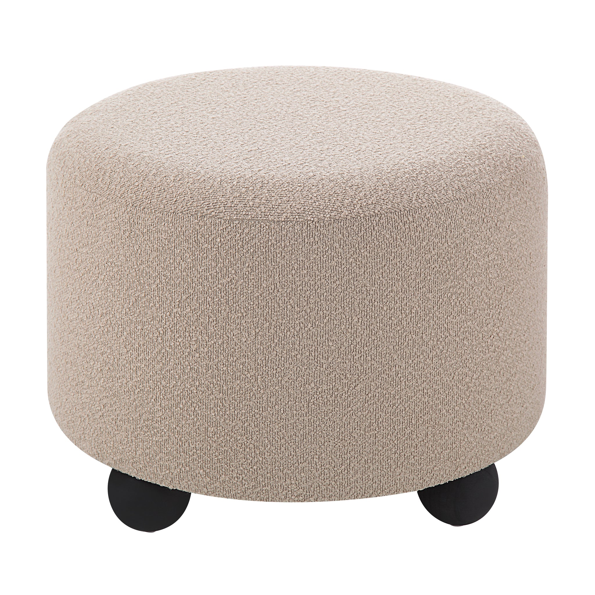 Claude Ottoman featuring a soft beige texture and rounded design with black feet