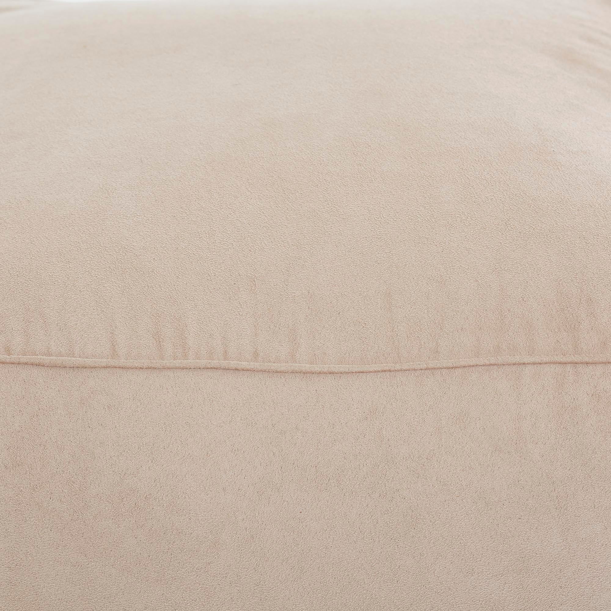 Close-up of Bundle Pouf in beige, highlighting the soft, velvety surface and seam details.
