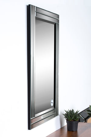 Baton Rouge Wall Mirror mounted on a wall, showcasing its stylish frame and surrounding decor.