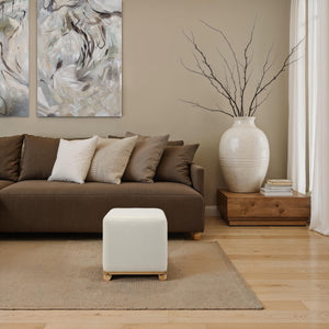 Sines Ottoman placed in a cozy living room with brown sofa and decorative vase