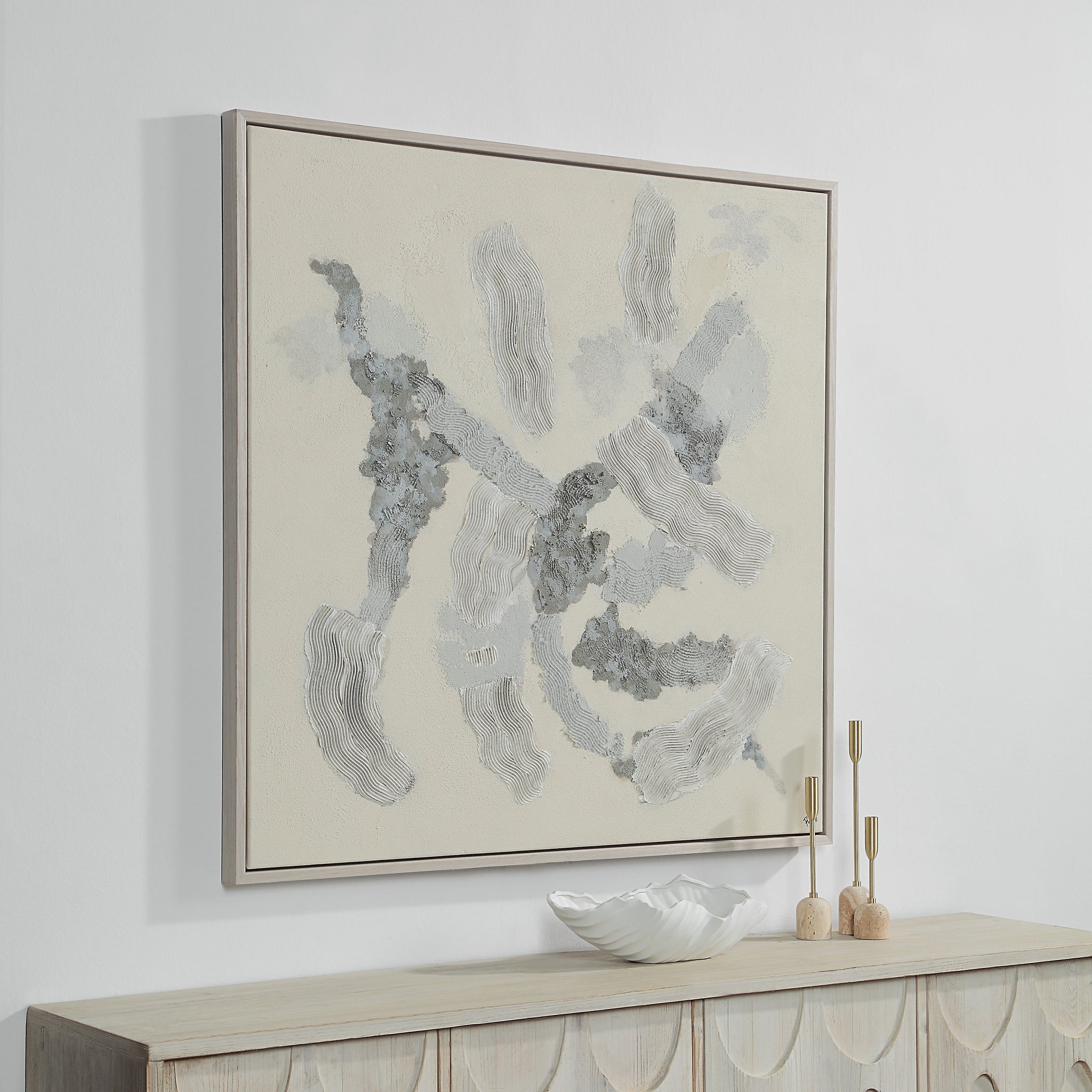 Maputo canvas art mounted on a wall above a wooden console with decorative items.