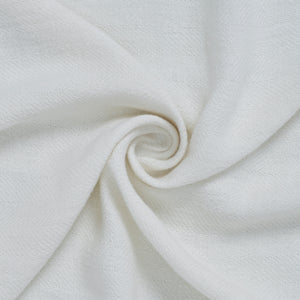 Ragusa Throw in white, showcasing a close-up of the soft fabric in a spiral arrangement.