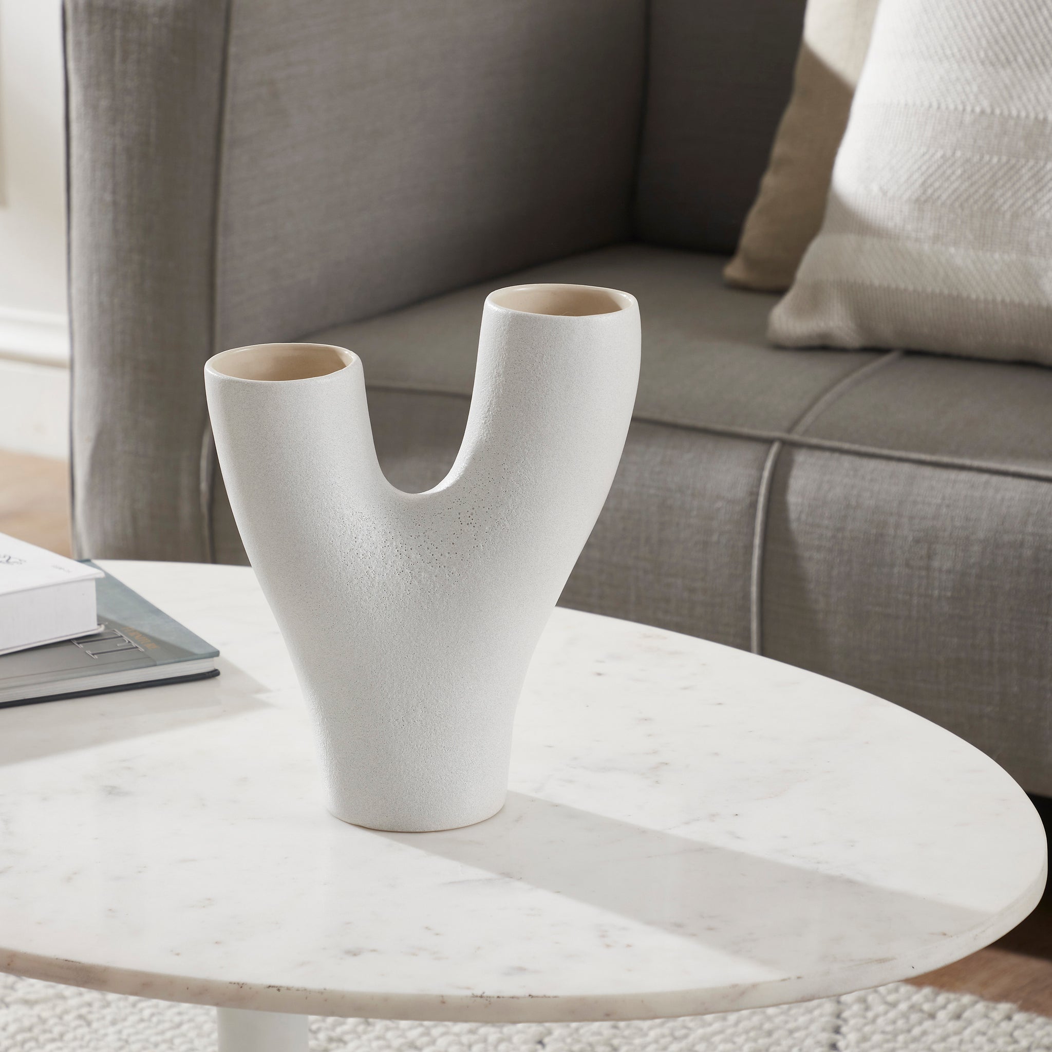 Jocasta Large Vase on a marble table in a living room setting, highlighting its design.