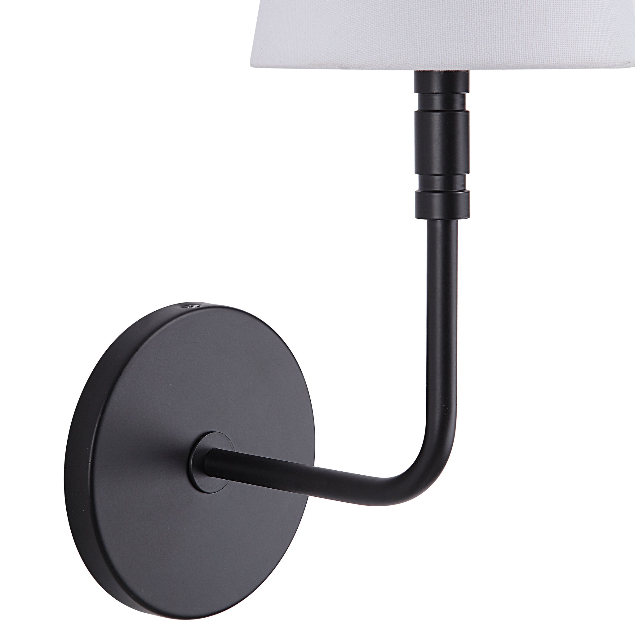 Andi Wall Sconce showing a close-up of the black arm and round base with a white fabric shade.