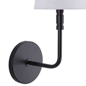 Andi Wall Sconce showing a close-up of the black arm and round base with a white fabric shade.