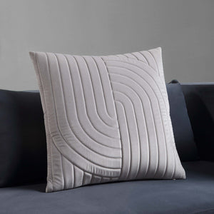 Ultar Indoor Pillow in light gray displayed on a dark sofa.