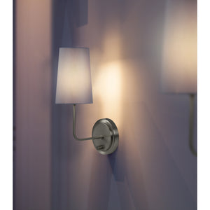 Hydra Wall Sconce featuring a white shade, casting light on a purple wall, with a brushed nickel finish.