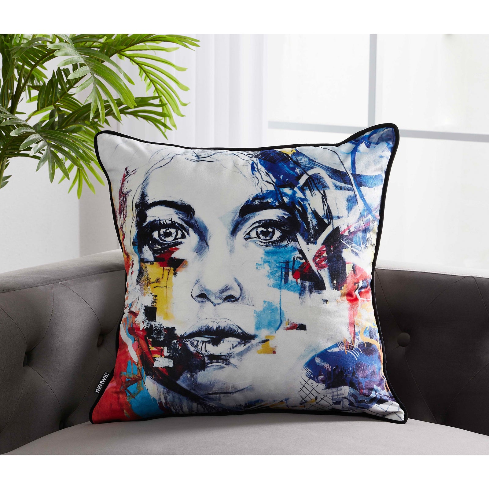 Tori Indoor Pillow featuring a colorful abstract face design with blue, red, and yellow accents.