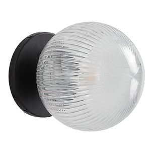 Brian Wall Sconce with clear ribbed glass globe and black metal base, side view.