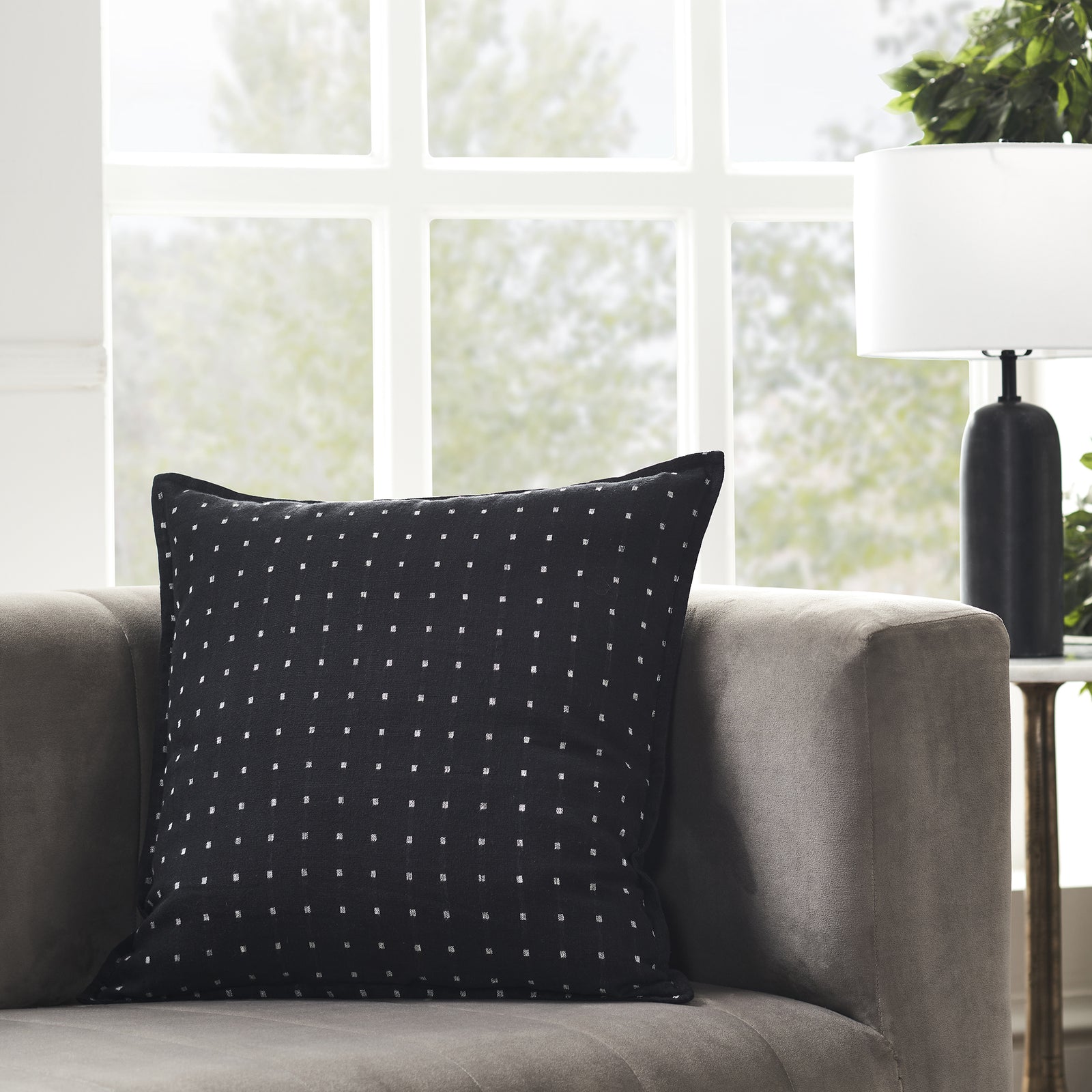 Brittany Indoor Pillow in black with white square pattern, showcasing textured fabric.