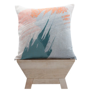 Tavira indoor pillow displayed on a wooden stand, showcasing abstract design in orange and teal