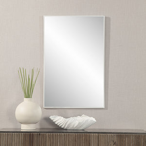 Orchid Wall Mirror displayed above a wooden table with decorative vase and bowl.