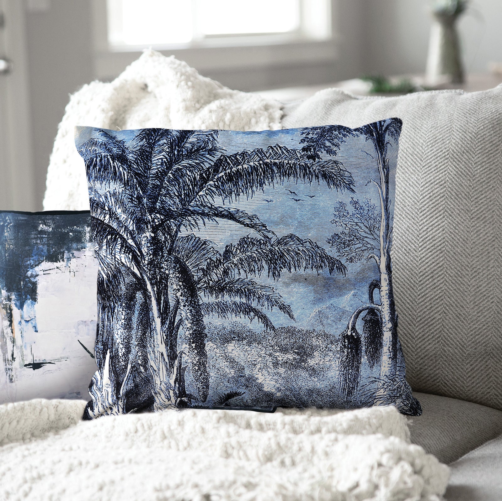 Jona Indoor Pillow featuring a blue and white palm tree design on a textured fabric.