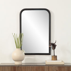 Dovima Wall Mirror displayed above a wooden console with decorative items.