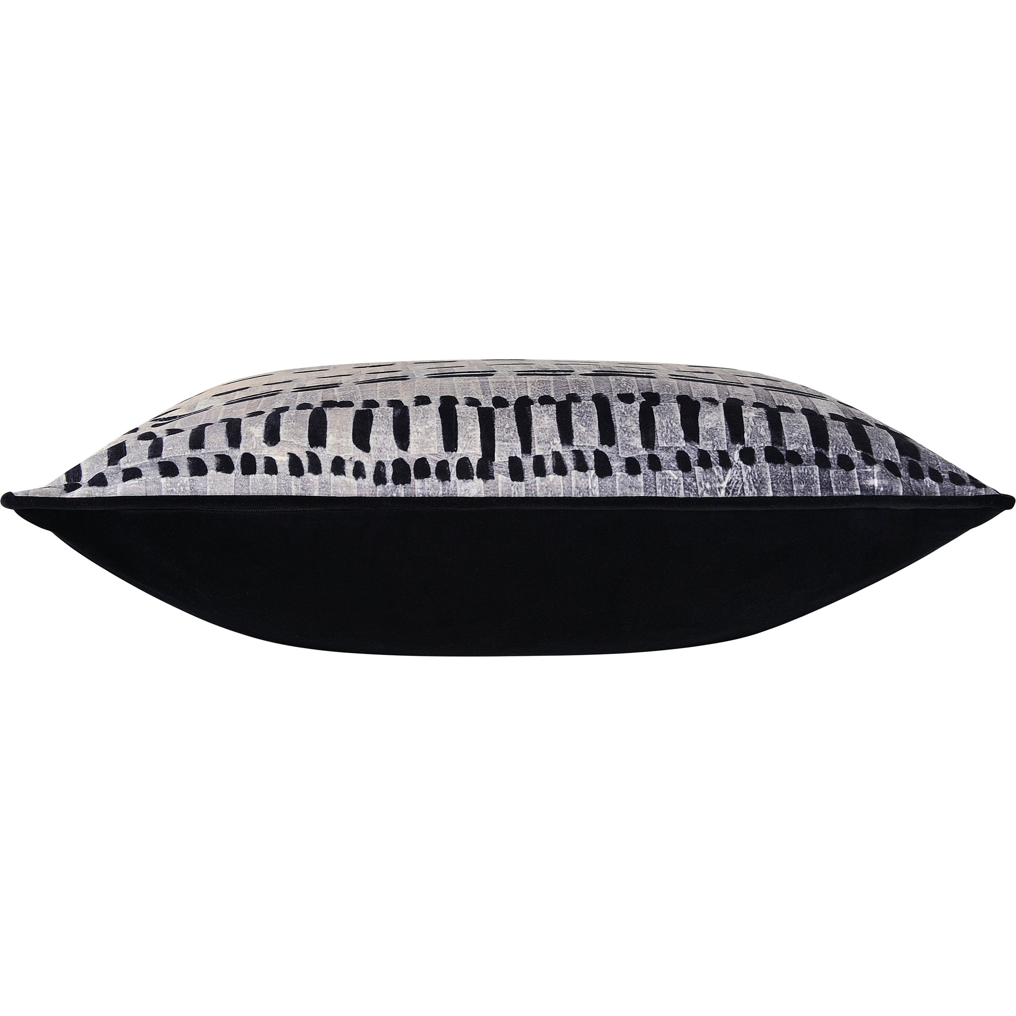 Side view of Zitsa Indoor Pillow displaying its plush black underside and patterned top