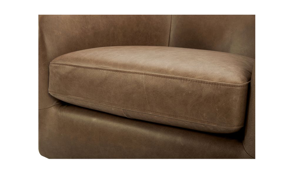 lifestyle view of Oscy Leather Swivel luxury Chair