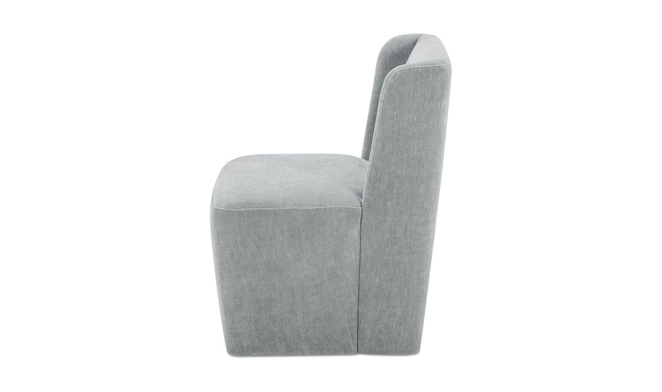 lifestyle view of Cormac Rolling Dining Chair Performance Fabric Slate Green luxury Chair