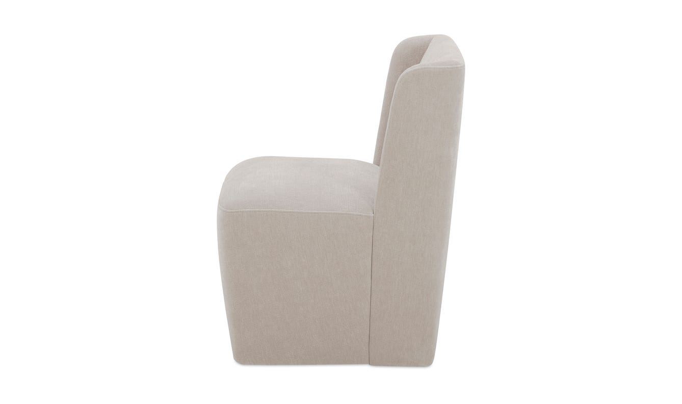 lifestyle view of Cormac Rolling Dining Chair Performance Fabric Warm Sand luxury Chair