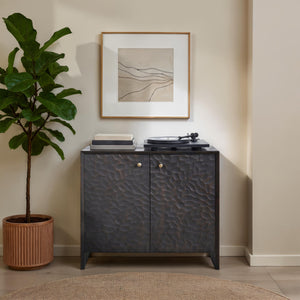 Jean Cabinet styled in a room with a plant, artwork, and a record player on top