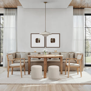 Dining area featuring two Persea stools in light beige, paired with a wooden table and chairs.