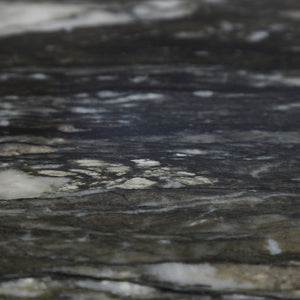 Detailed view of the black marble top of Adeline Side Table, emphasizing its natural patterns.