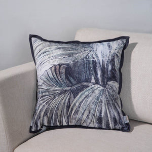 Mangrove Indoor Pillow on a light sofa, showcasing a detailed palm leaf pattern.