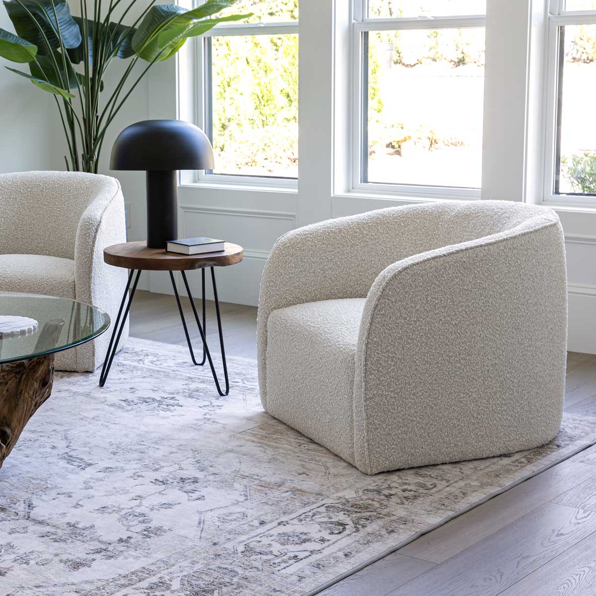 Modern living room with beige armchair, side table, and decorative lamp.