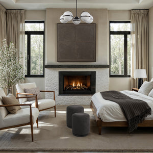 Roca ceiling fixture in a bedroom, displaying five white marble globes above a modern fireplace and seating.