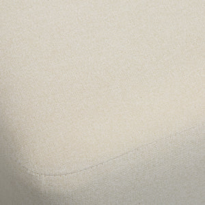 Sines ottoman in light beige fabric with a textured pattern and rounded edges, showcasing a close-up view of the upholstery.