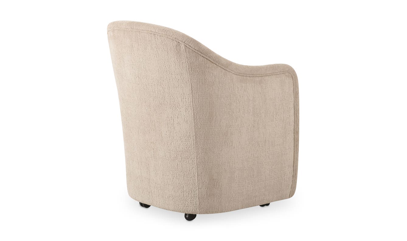 lifestyle view of Drava Rolling Dining Chair luxury Chair