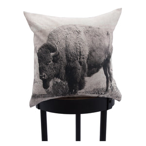 Russ indoor pillow with a buffalo design, displayed on a black stool for contrast.